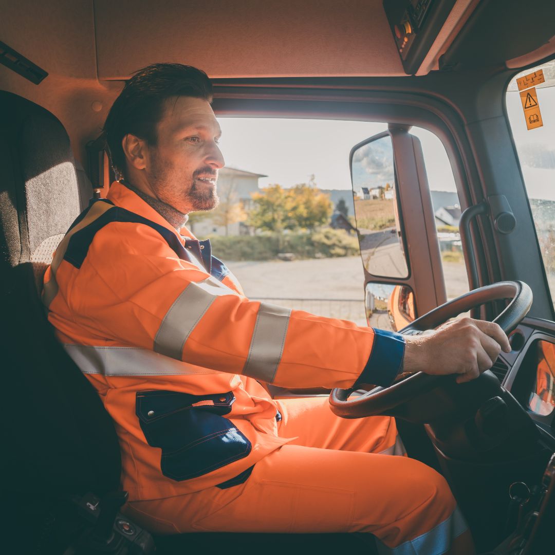 a truck driver with a bright orange construction outfit