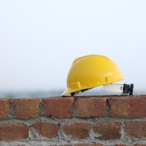 Hard hat on brick wall